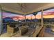 Relaxing screened-in porch with comfortable seating and views of the gorgeous sunset over the canal at 1918 Massachusetts Ave, Englewood, FL 34224