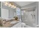 Well-maintained bathroom featuring granite countertop, decorative mirror and shower enclosure at 2103 L Pavia Blvd # 2103, Venice, FL 34292