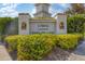 Community sign for L' PAVIA A CONDOMINIUM VISTA DEL LAGO with lush green landscaping at 2103 L Pavia Blvd # 2103, Venice, FL 34292
