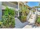 Attractive condo exterior with well-maintained landscaping, stairs, and screened porches at 2103 L Pavia Blvd # 2103, Venice, FL 34292