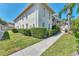 Well-maintained building exterior with manicured landscaping and sidewalk at 2103 L Pavia Blvd # 2103, Venice, FL 34292