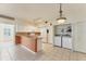 Bright kitchen featuring white cabinetry, stainless appliances, and a convenient washer/dryer closet at 2103 L Pavia Blvd # 2103, Venice, FL 34292