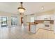 Open-concept kitchen with granite countertops, white cabinets, and seamless flow to living area at 2103 L Pavia Blvd # 2103, Venice, FL 34292