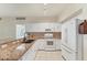 Well-lit kitchen with white cabinetry, granite countertops, and stainless steel appliances at 2103 L Pavia Blvd # 2103, Venice, FL 34292