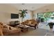 Relaxing lounge area with plush wicker furniture and sliding doors to the pool at 2103 L Pavia Blvd # 2103, Venice, FL 34292