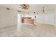 Open-concept living room featuring tile flooring, a ceiling fan, and ample natural light at 2103 L Pavia Blvd # 2103, Venice, FL 34292