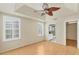 Bright main bedroom features tray ceiling, ceiling fan, ensuite bathroom and walk-in closet at 2103 L Pavia Blvd # 2103, Venice, FL 34292
