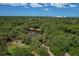Expansive aerial view of a lush park with a pond and fountain, surrounded by trees at 2111 Ivory Pl, Sarasota, FL 34239