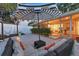 Inviting back patio with cushioned seating area and striped umbrella, view into adjacent living area at 2111 Ivory Pl, Sarasota, FL 34239