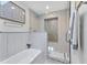 Modern bathroom featuring a sleek tub, glass shower, and stylish tile accents at 2111 Ivory Pl, Sarasota, FL 34239