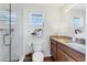 Bathroom with shower, vanity with single sink, decor and window at 2111 Ivory Pl, Sarasota, FL 34239