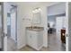 Cozy bathroom vanity with granite countertops, a framed mirror, and bright lighting at 2111 Ivory Pl, Sarasota, FL 34239