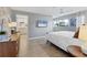 Cozy bedroom with wood floors, a television, and a view of the bathroom at 2111 Ivory Pl, Sarasota, FL 34239