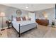 Serene bedroom with a queen-sized bed, wood floors, and elegant decor at 2111 Ivory Pl, Sarasota, FL 34239