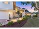 Inviting front entrance with manicured flowerbeds, palm trees, and a walkway that welcomes you home at 2111 Ivory Pl, Sarasota, FL 34239