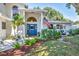 Charming home featuring a blue front door, decorative wreath, manicured landscaping, and an American flag at 2111 Ivory Pl, Sarasota, FL 34239