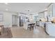 Bright kitchen featuring white cabinets, stainless steel appliances, a center island, and tile flooring at 2111 Ivory Pl, Sarasota, FL 34239