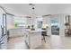 Bright kitchen with stainless steel appliances, white cabinets, center island with bar stool seating at 2111 Ivory Pl, Sarasota, FL 34239