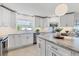 Kitchen with white cabinetry, stainless steel appliances, and marble countertops, and a pendant light at 2111 Ivory Pl, Sarasota, FL 34239