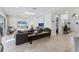 Inviting living room with comfortable seating, a skylight, and access to the outdoor area at 2111 Ivory Pl, Sarasota, FL 34239