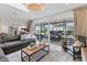 Bright living room with access to the backyard patio, featuring tile flooring and neutral decor at 2111 Ivory Pl, Sarasota, FL 34239