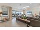 Cozy living room with tile flooring, a large sectional sofa, a TV, and sliding glass doors at 2111 Ivory Pl, Sarasota, FL 34239
