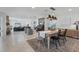 Open-concept living space with tile floors, dining table, living room and a view of the staircase at 2111 Ivory Pl, Sarasota, FL 34239
