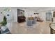 Open living space with tile flooring, a sitting area, dining table, and white doors with an arched entry at 2111 Ivory Pl, Sarasota, FL 34239