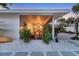 Screened patio with dining and seating areas, surfboards, and lush greenery at 2111 Ivory Pl, Sarasota, FL 34239