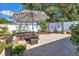Beautiful patio with wicker seating, a large umbrella, and a cozy hammock for outdoor enjoyment at 2111 Ivory Pl, Sarasota, FL 34239