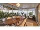 Relaxing screened patio with dining area and cushioned chairs surrounded by lush landscaping for privacy at 2111 Ivory Pl, Sarasota, FL 34239