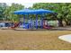 A colorful playground with two canopies, slides, and climbing equipment at 2111 Ivory Pl, Sarasota, FL 34239