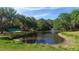 Picturesque pond featuring a fountain, bridge, and surrounding natural landscape at 2111 Ivory Pl, Sarasota, FL 34239