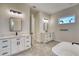 Bright bathroom featuring dual vanities, sleek fixtures, and a modern soaking tub at 217 Rotonda S Blvd, Rotonda West, FL 33947