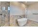 Bathroom featuring a soaking tub, tiled shower, and stone accent wall at 217 Rotonda S Blvd, Rotonda West, FL 33947