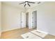 Bright bedroom with hardwood floors and modern ceiling fan; closet and ensuite bathroom doors visible at 217 Rotonda S Blvd, Rotonda West, FL 33947