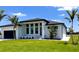 New single-Gathering home with manicured landscaping, modern design, and a two-car garage at 217 Rotonda S Blvd, Rotonda West, FL 33947