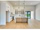 Bright kitchen features white cabinets, stainless steel appliances, and a central island at 217 Rotonda S Blvd, Rotonda West, FL 33947