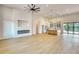A spacious living room with a modern fireplace, kitchen, and access to the pool at 217 Rotonda S Blvd, Rotonda West, FL 33947