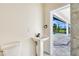 Tastefully designed powder room with modern fixtures and an inviting view of the pool area at 217 Rotonda S Blvd, Rotonda West, FL 33947