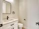 Powder room with black fixtures and a white vanity with a marble countertop at 217 Rotonda S Blvd, Rotonda West, FL 33947