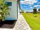 Side exterior with tiled path and green lawn at 217 Rotonda S Blvd, Rotonda West, FL 33947