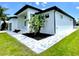 Landscaped side exterior featuring a tiled walkway and lush greenery at 217 Rotonda S Blvd, Rotonda West, FL 33947
