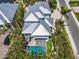 Aerial view of the property featuring a pool, modern staircase, and lush tropical landscaping at 222 Willow Ave, Anna Maria, FL 34216