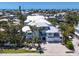 Aerial view of a stunning property with a metal roof, balconies, meticulous landscaping, and an oversized lot at 222 Willow Ave, Anna Maria, FL 34216
