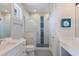 Charming bathroom featuring white cabinets, subway tiles, and glass-enclosed shower at 222 Willow Ave, Anna Maria, FL 34216