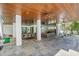 Expansive covered patio with dining and lounge areas, ideal for entertaining at 222 Willow Ave, Anna Maria, FL 34216
