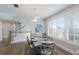 Elegant dining area with modern chandelier, setting the stage for memorable meals at 222 Willow Ave, Anna Maria, FL 34216