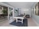 Light and bright game room with pool table, sliders to pool, tv, and coastal decor at 222 Willow Ave, Anna Maria, FL 34216
