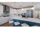 Kitchen with a large island, white cabinets, stainless steel appliances, and hardwood flooring at 222 Willow Ave, Anna Maria, FL 34216